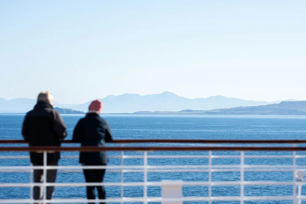 Guests enjoying a coffee on deck in the sunshine 1